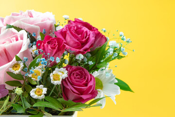 Beautiful summer banner for a website with a bouquet of bright flowers on a modern pink background. Bouquet of pink roses, chrysanthemums and daisies top view, free space for text