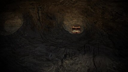 A treasure chest hidden deep within a cave, full of gold coins, gold chalices, goblets, emeralds, and gemstones.