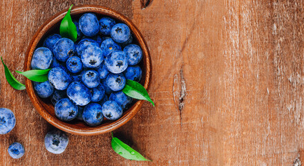 Blueberries in a bowl on a wooden background top view free space for text