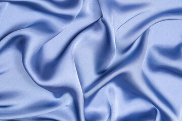 Blue silk or satin luxury fabric texture. Top view.