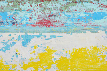 Abstract paint background with random patterns of layers of aged and weathered paint on a wood surface