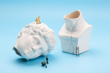 Workers are repairing the broken sculpture of David's head