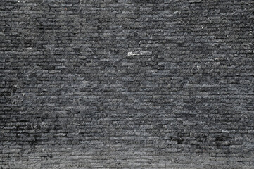 Old Black Brick wall is a block texture background for design and decoration.