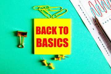 BACK TO BASICS is written in red on a yellow sticker on a green background near the graph and pencil