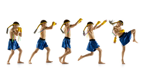 Little boy exercising thai boxing on white background. Fighter practicing, training in martial arts in action, motion. Evolution of movement, catching moment.