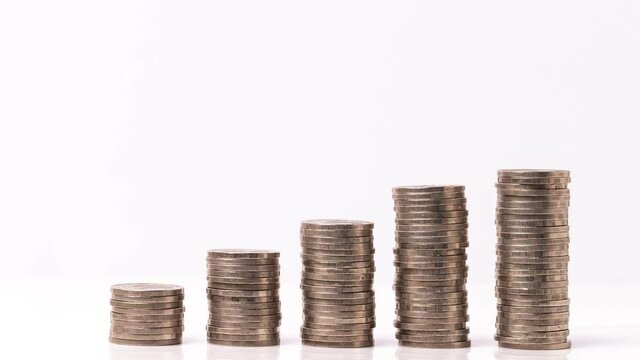 4k stop motion five piles of gold money coins decreasing fading disappear on white background, financial trading concept.