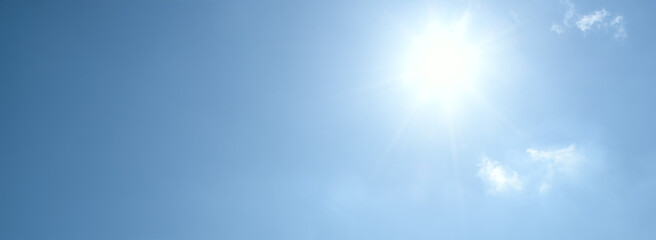 Fototapeta na wymiar Sun and direct sunlight on a clear blue sky with copy space