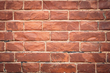 Red brick wall, bricks background, grunge texture. Decorative tile surface. Rough brickwork. Brown wallpaper, design in rustic style. Stones pattern.