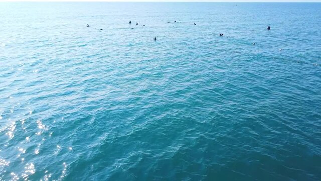 Calm sea with birds visible in the distance.