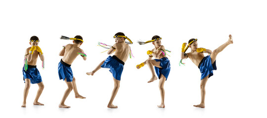 Little boy exercising thai boxing on white background. Fighter practicing, training in martial arts in action, motion. Evolution of movement, catching moment.