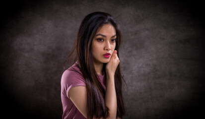 Pretty Asian woman - portrait shot against grey background - studio photography