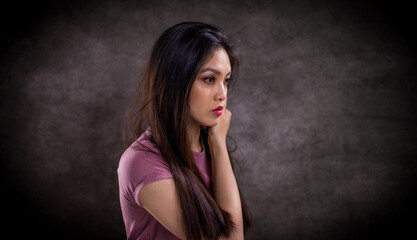 Pretty Asian woman - portrait shot against grey background - studio photography