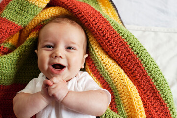 Caucasian baby boy with hands clasped