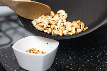 Roasted cashews in a pan. Delicious snack.