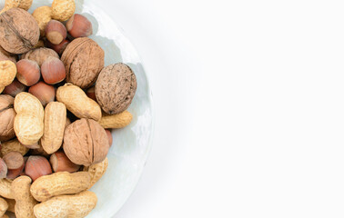 Blend of nuts on half plate. Concept of healthy and proper nutrition.