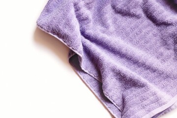 Purple cotton towel for hairs isolated on a white background. Flat lay photography