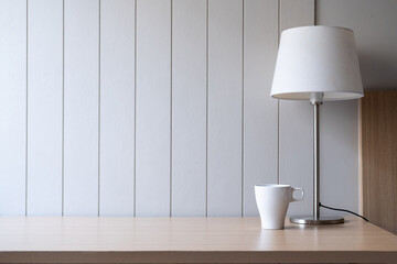 Workplace with space - Lamp on old wood table with space of rough cement wall in white color tone