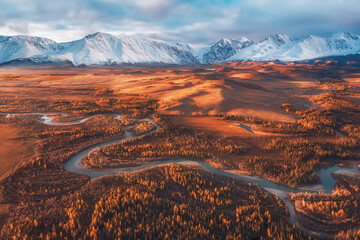 sunrise over the autumn steppe with the river against the background of mountains Altai Chuya Kurai