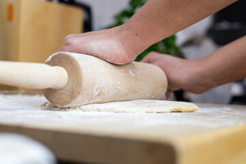 A person rolling the dough for homemade lasagne pasta.