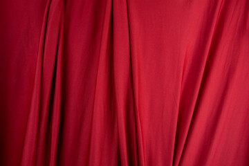 Texture, background, template. Silk fabric. Red silk drapery and upholstery fabric. Solid fabrics for backdrop, drapes, flags and curtains