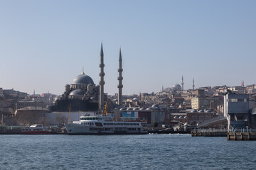 Fototapeta na wymiar The Karakoy Pier in Istanbul offers views of the Golden Horn Bay and the Suleymaniye Grand Mosque. Nice day for sea walking in through the Golden Horn and Bosphorus straits on the sea transport.