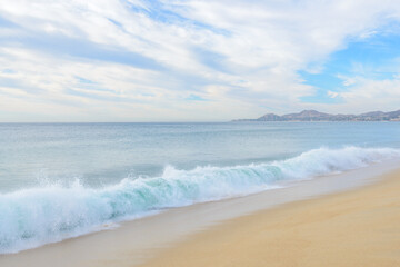 Set of pictures of a fantastic ocean wave in different stages. Cloudy sunrise sky. San Jose del Cabo. Mexico.