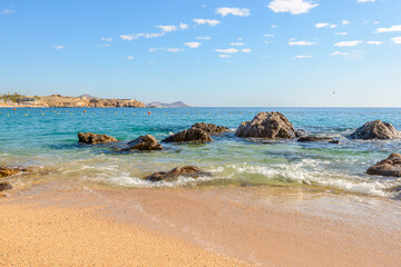 Playa el Chileno Beach, Cabo San Lucas, Mexico. Different stages of the fantastic ocean waves. Rocky and sandy beach.