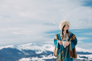 Young woman walks against beautiful landscape of mountains and sky.