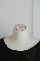 Black blouse with a round neck on a mannequin