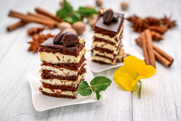 A slice of chocolate honey cake with custard