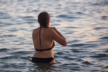 Girl in a swimsuit in the sea water