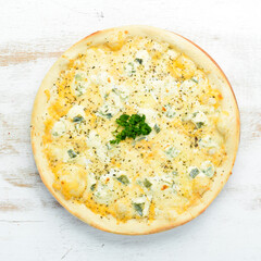 Four cheese pizza. Blue cheese, mozzarella, brie. Top view. free space for your text. Rustic style.