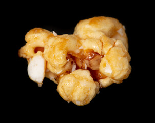 Close-up of popcorn flakes on a black background.