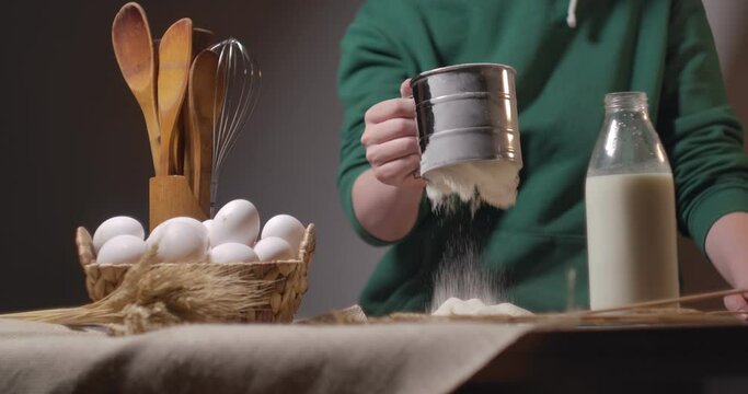 Making cake batter, sifting flour to make it more airy.  slow motion

