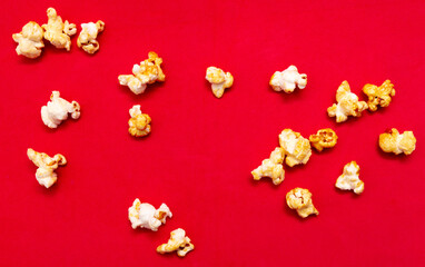 Close-up of popcorn on a red background.