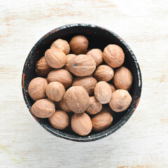 Spices. Nutmeg in a bowl. Free space for your text. Top view.