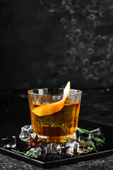 Alcoholic cocktail negroni with orange peel. On a black background. Top view.