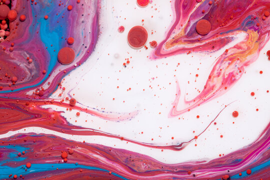 Abstract background of mixed red, blue, white, and pink oily paints