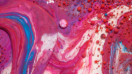 Abstract background of mixed red, white, and pink oily paints