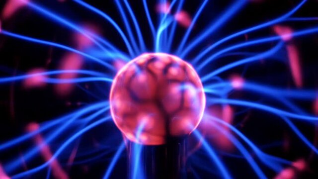 Plasma ball lamp with moving filaments extending from pink center. Close up view. Multiple beams of colored light, waves radiating, pulsation. 4K UHD 4096x2304 ultra high definition

