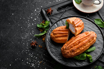 Eclair with cream. Sweets. Top view, free copy space.