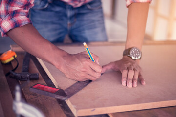 Portrait of a carpenter working happily in his shop. Creating a product from wood Happy work concept