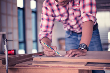 Portrait of a carpenter working happily in his shop. Creating a product from wood Happy work concept