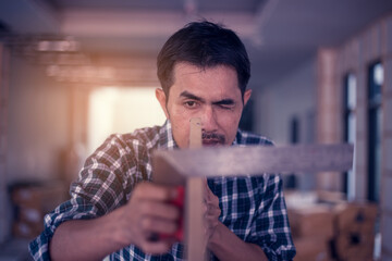 Portrait of a carpenter working happily in his shop. Creating a product from wood Happy work concept