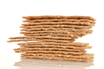Several multigrain thin crisps, close-up, isolated on white.