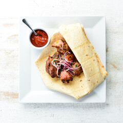 Veal kebab with onions in pita bread. Meat skewers. Top view.