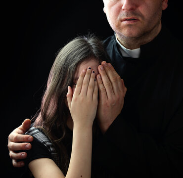 priest and young girl covering her face
