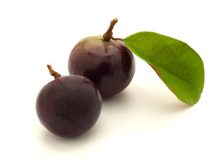 Ripe purple star apple fruit with leaves on a white background. Space for text. Concept of healthy fruits