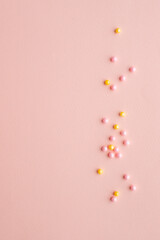 Pink sprinkles background, sugar sprinkle hearts, decoration for cake and bakery. Top view, flat lay. pastel colors