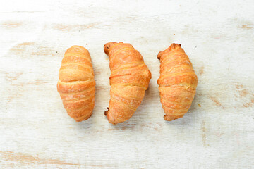 Fresh French croissants with chocolate. Baking from rye and flour. Top view. Rustic style.